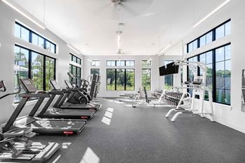 Spacious fitness center with floor to ceiling windows